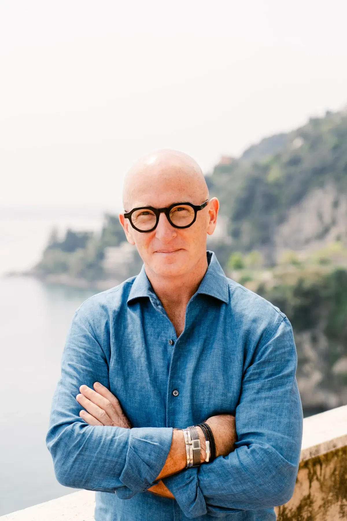 Coastal portrait — blue-grey linen, golden hour.